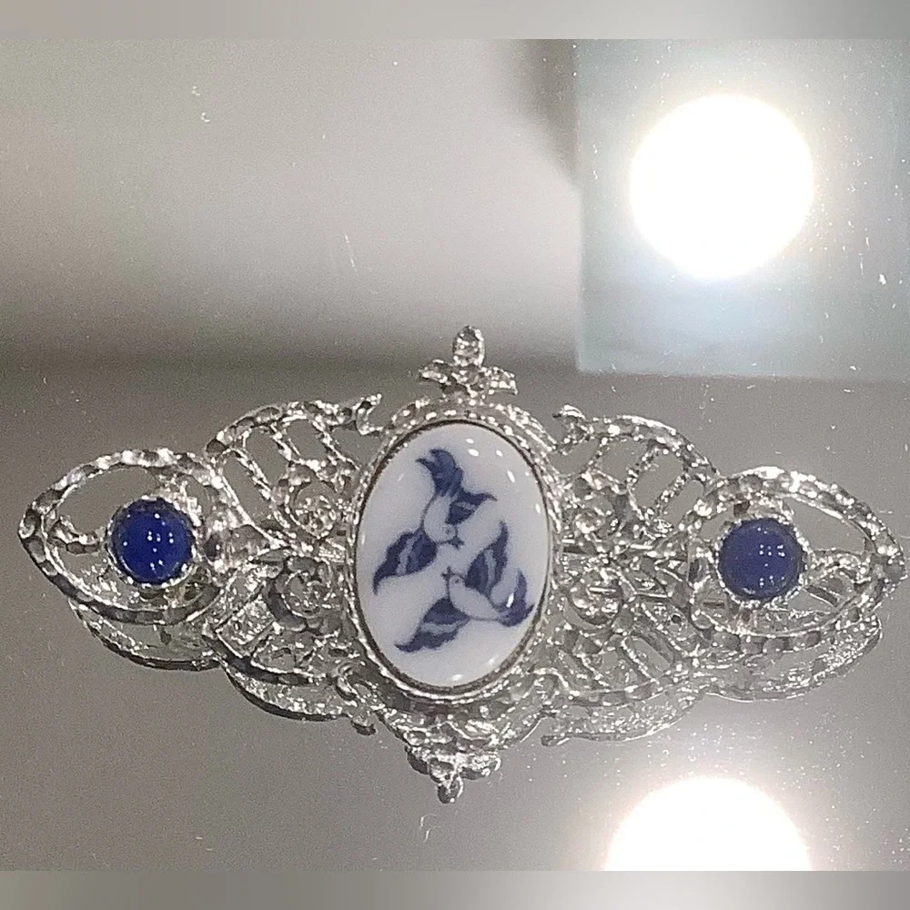 Silver-Tone Filigree Brooch with Blue/White Bird Design